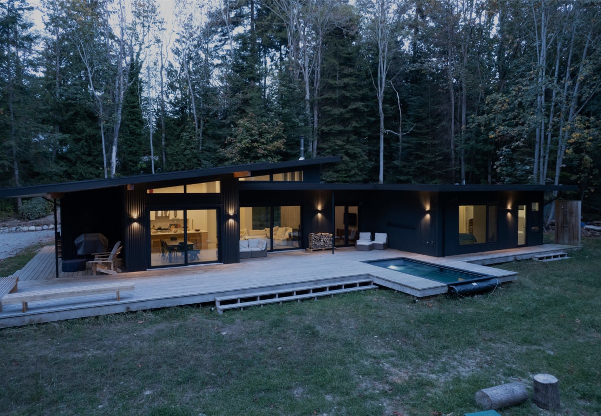 A sleek, modern facade featuring expansive windows and a minimalist design, creating a luxurious first impression