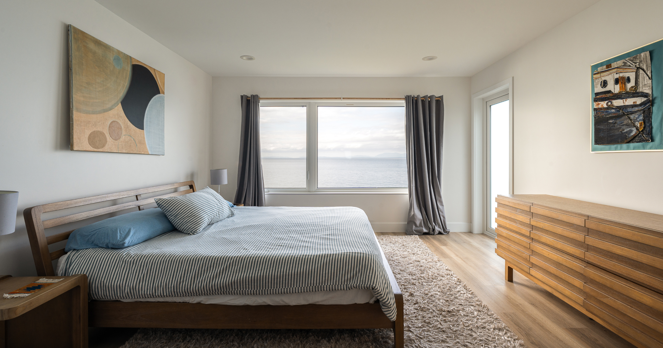 The luxurious master bedroom boasts a king-sized bed, soft lighting, and panoramic views of the surrounding landscape