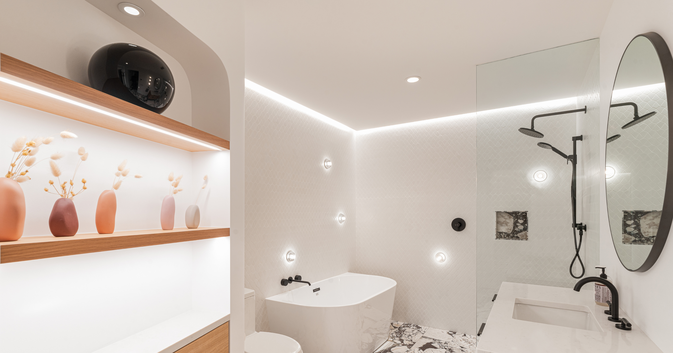 This well-appointed bathroom features a mix of textures, and custom built-ins